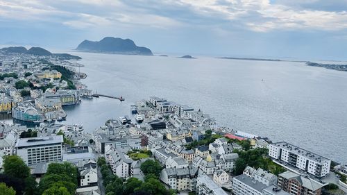 High angle view of townscape by sea against sky