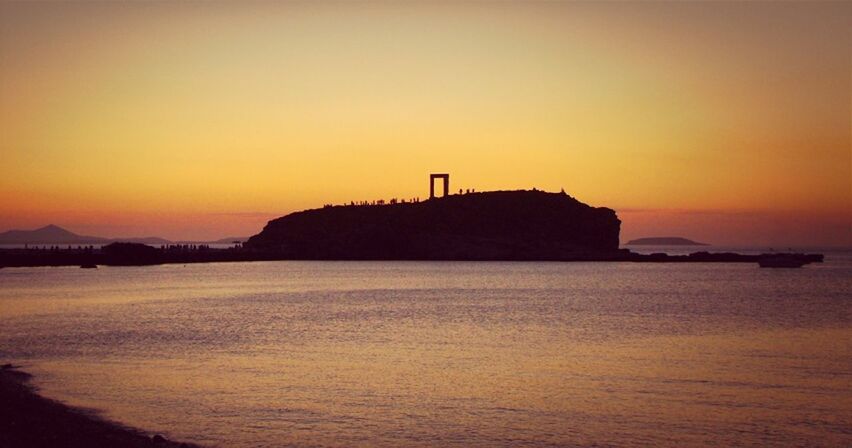 sunset, water, sea, silhouette, orange color, scenics, tranquil scene, copy space, tranquility, beauty in nature, clear sky, waterfront, nature, idyllic, mountain, dusk, beach, sky, built structure, coastline