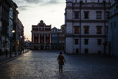 Rear view of man standing in city