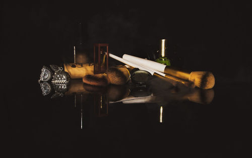 Close-up of wine bottles on table against black background