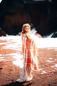 Portrait of woman wearing hat standing on land