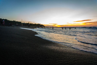 Scenic view of beach against sky during sunset