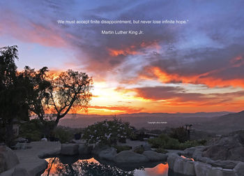 Scenic view of mountains against sky at sunset