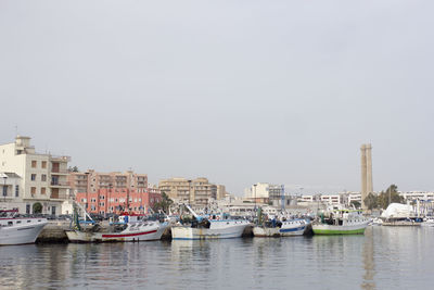 Boats moored at harbor against sky at monopoli