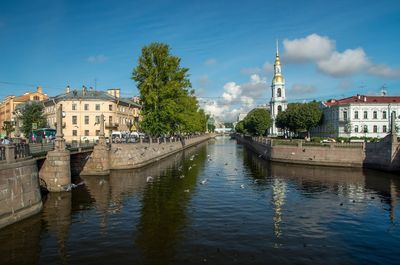 Canal amidst st nicholas naval cathedral and buildings against sky