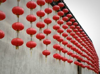 Low angle view of chinese lanterns hanging by wall