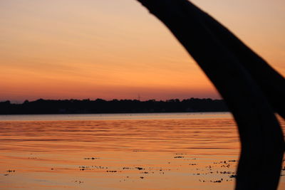 Scenic view of lake against orange sky