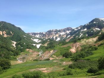 Scenic view of mountains against cloudy sky