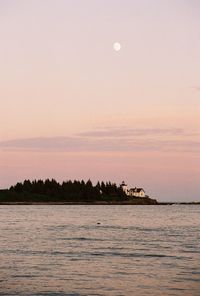 Scenic view of lake against sky at sunset