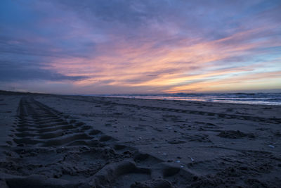 Scenic view of beach against sky during sunset