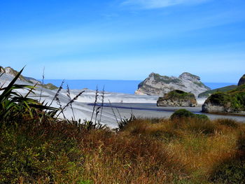 Scenic view of sea against blue sky