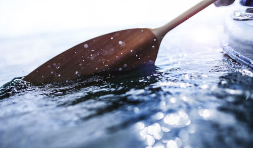 Oars splashing in fresh water with energy