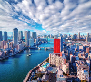 Aerial panoramic view of morning sumida river in tokyo under dramatic cloudy sky