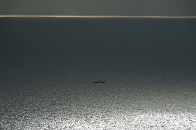 View of birds flying over sea against sky