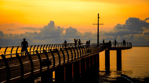 Pier over sea against sky during sunset wharf dawn