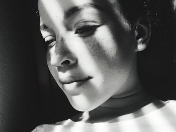 Close-up portrait of beautiful young woman looking away