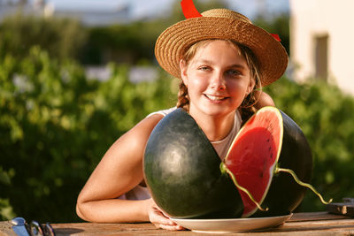 Happy smiling girl with half red fresh watermelon enjoying summer life outdoors. summer lifestyle