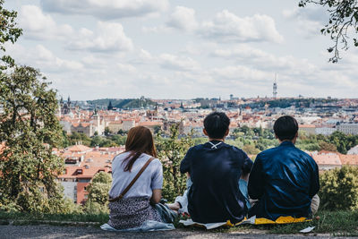 Rear view of people looking at cityscape