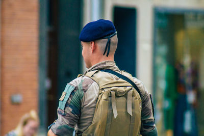 Rear view of man standing at camera