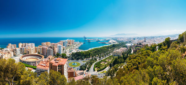 High angle view of buildings and sea against sky