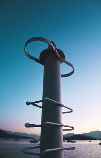 Close-up of metal chain against clear sky