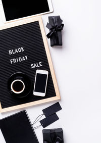 High angle view of camera on table against white background