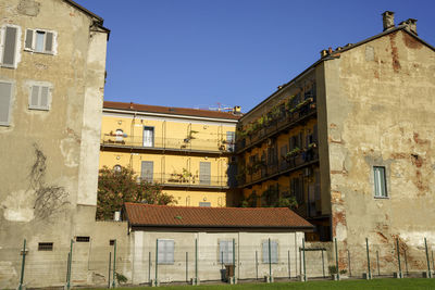 Buildings against clear blue sky