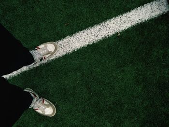 Low section of man standing on playing field