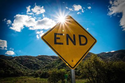 Information sign on landscape against blue sky