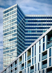 Low angle view of modern building in city against sky