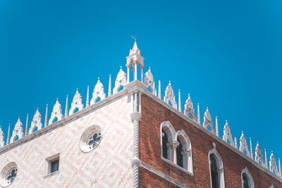 Low angle view of building against blue sky