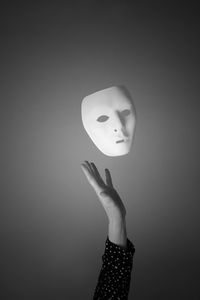 Person wearing mask against white background