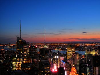 High angle view of city lit up at night