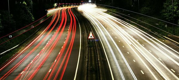 High angle view of light trails on highway at night