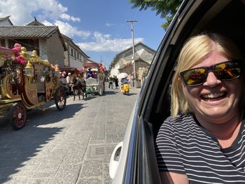 Portrait of smiling young woman in sunglasses