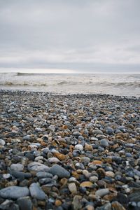 View of pebbles on beach against sky