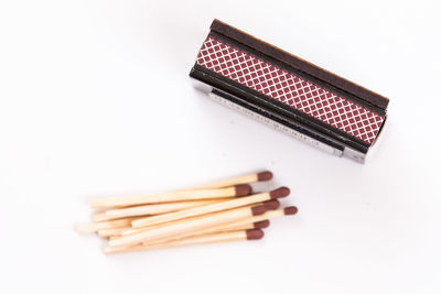 High angle view of pencil on table against white background