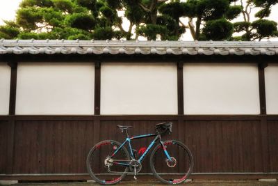 Bicycle outside house against building