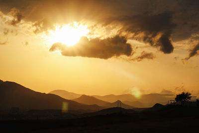 Scenic view of silhouette mountains against sky during sunset