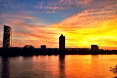 River with buildings in background at sunset