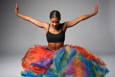 Portrait of dancer wearing multi colored skirt