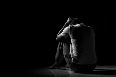 Man sitting in darkroom