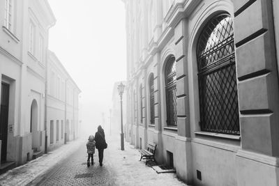 Man walking on road in city