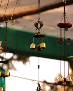 Close-up of wind chimes hanging in store for sale