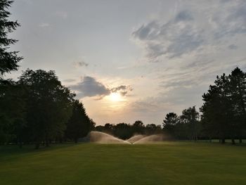 View of golf course against sky during sunset