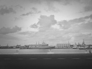 Harbor against cloudy sky