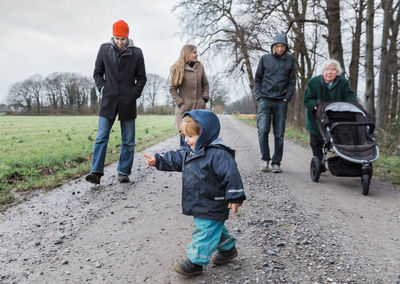 Family walking on road during winter