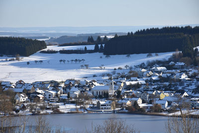 Scenic view of lake against clear sky during winter