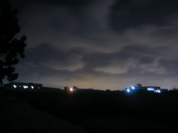 Scenic view of illuminated landscape against sky at night
