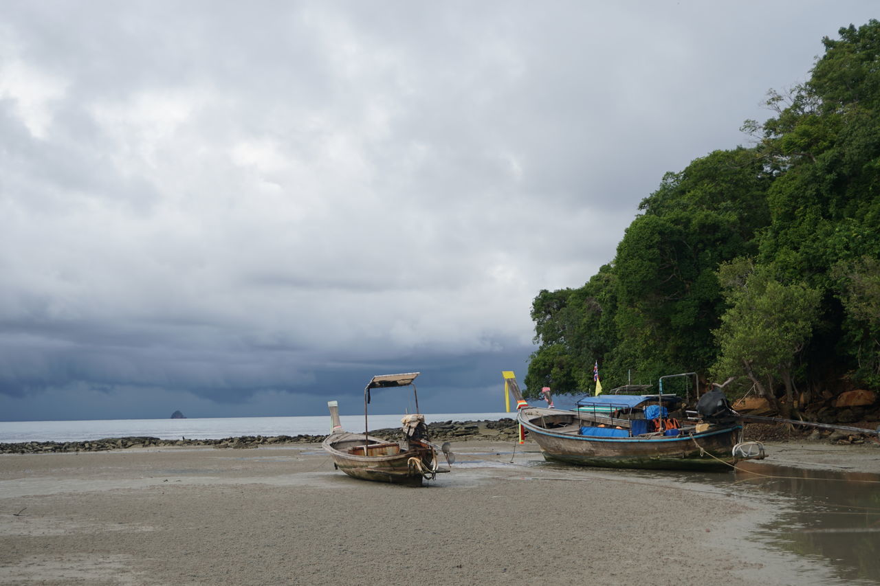 BOATS MOORED ON SEA AGAINST SKY